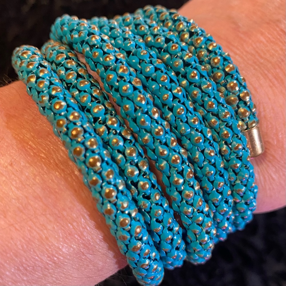 Turquoise and gold toned wrap bracelet fits most wrists 1 3/4” by 2 1/2” across
